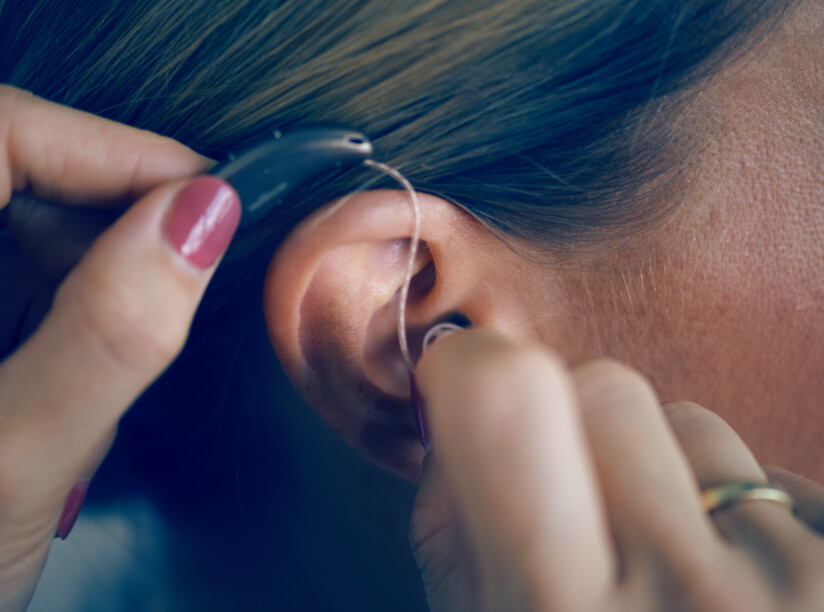 BTE hearing aids being inserted